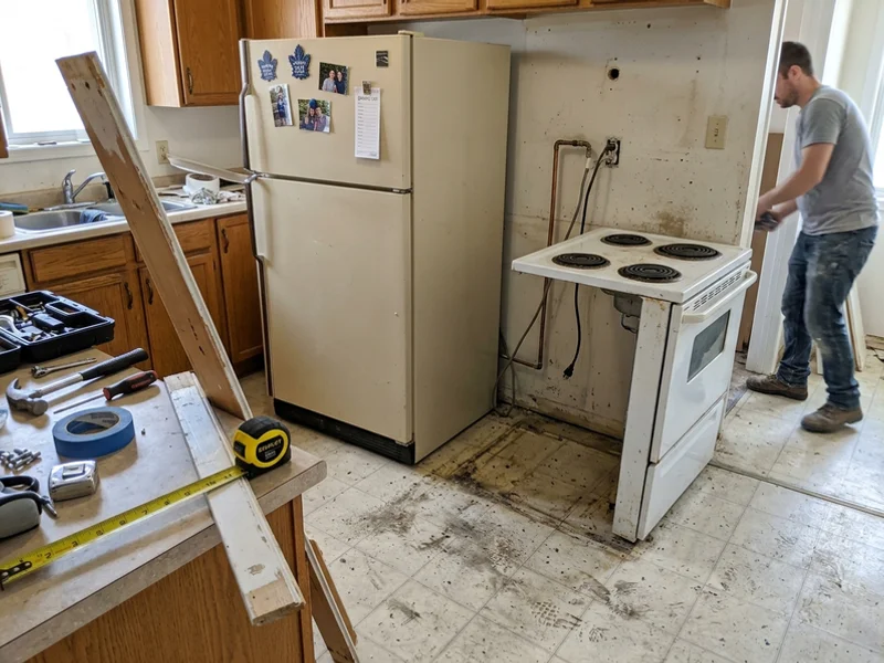 Old fridge and stove pulled out ready for removal